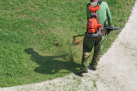 Landscaper with weed wacker